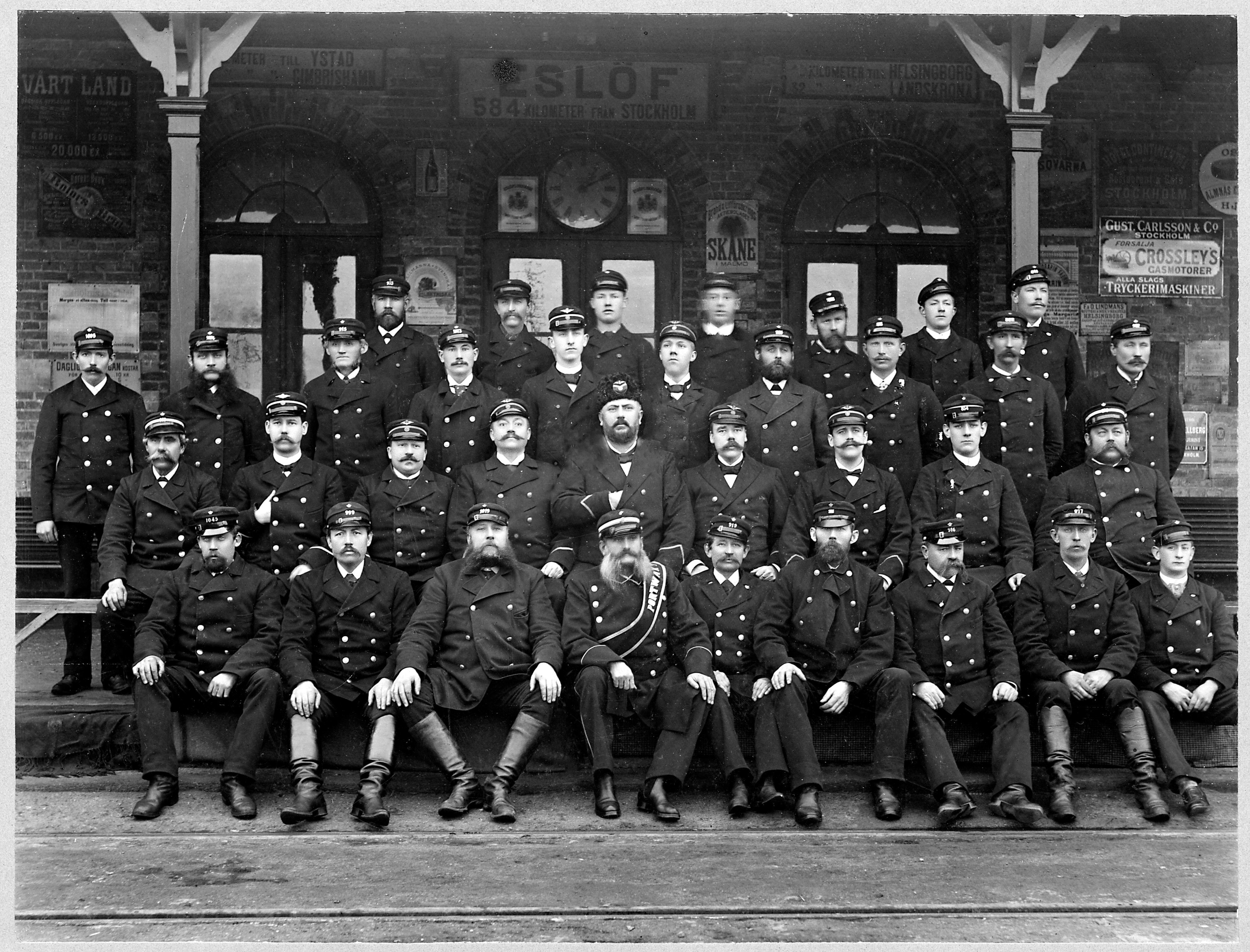 Personal utanf&ouml;r Esl&ouml;v J&auml;rnv&auml;gsstation. 1900-1920. K&auml;lla: digitaltmuseum.se/J&auml;rnv&auml;gsmuseet.